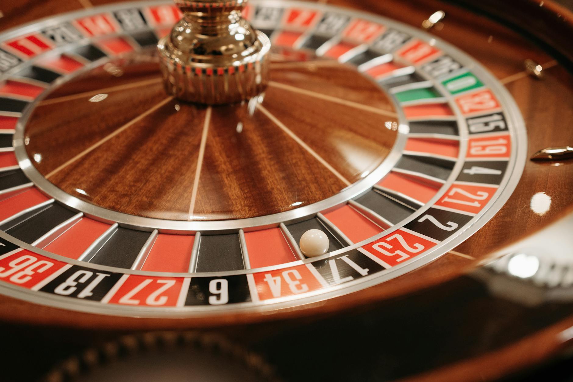 A detailed close-up of a spinning roulette wheel with the ball in play, capturing the essence of casino excitement and gambling.